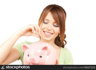 picture of lovely teenage girl with piggy bank and coin
