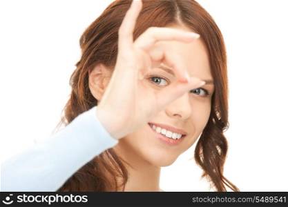 picture of lovely woman looking through hole from fingers