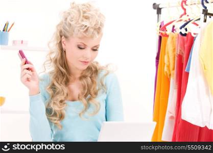 picture of lovely woman with cell phone and computer