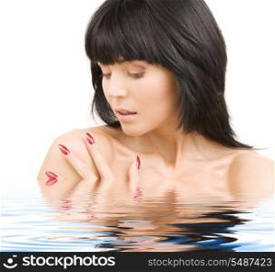 picture of lovely woman with red nails in water