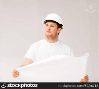 picture of male architect in helmet looking at blueprint
