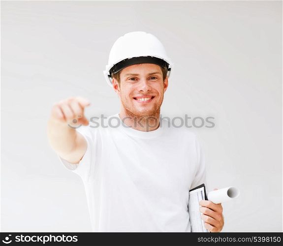 picture of male architect in helmet pointing at you
