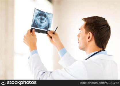 picture of male doctor or dentist looking at x-ray