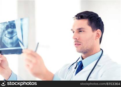 picture of male doctor or dentist looking at x-ray. male doctor or dentist looking at x-ray