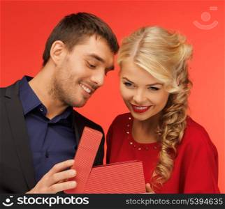 picture of man and woman looking inside the box