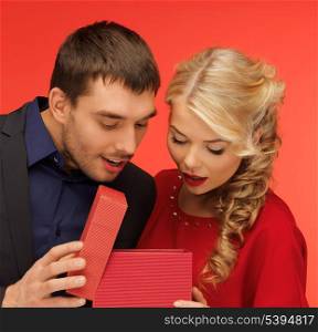 picture of man and woman looking inside the box