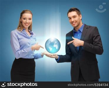 picture of man and woman showing earth globe on the palms