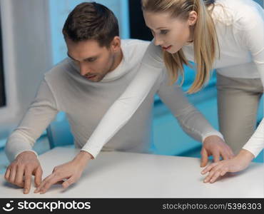 picture of man and woman working with something imaginary