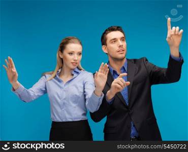 picture of man and woman working with something imaginary.