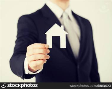 picture of man hand holding paper house