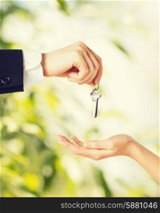 picture of man hand passing house keys to woman
