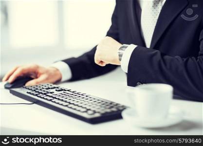 picture of man hands typing on keyboard and watching time