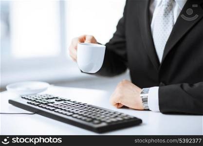 picture of man hands with keyboard drinking coffee