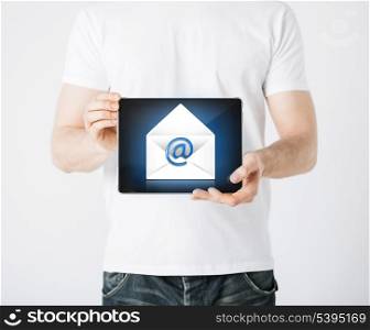 picture of man holding tablet pc with email sign
