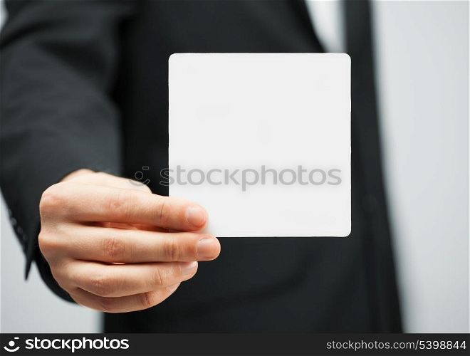 picture of man in suit holding blank card