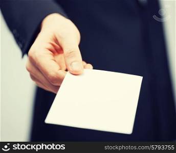 picture of man in suit holding credit card