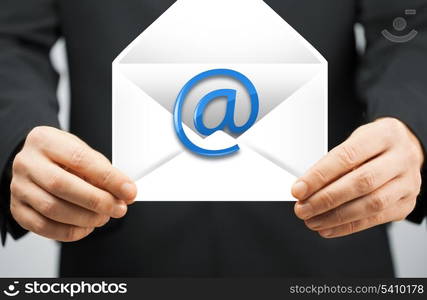 picture of man in suit holding envelope with email sign