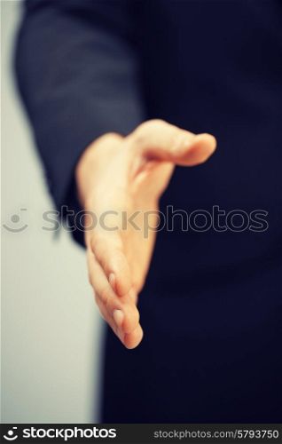 picture of man in suit with an open hand .