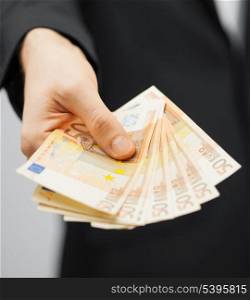 picture of man in suit with euro cash money.