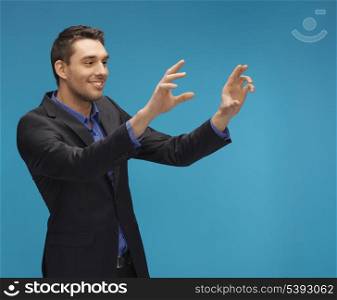 picture of man in suit working with something imaginary.