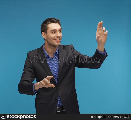 picture of man in suit working with something imaginary.