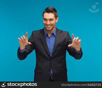 picture of man in suit working with something imaginary.