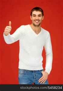 picture of man in warm sweater showing thumbs up.
