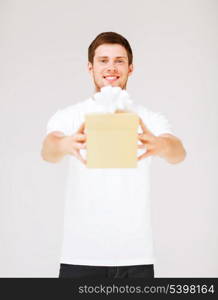 picture of man in white t-shirt with gift box