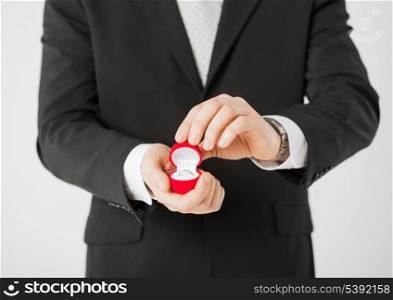 picture of man with gift box and wedding ring