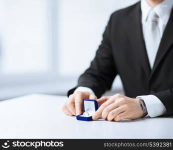 picture of man with gift box and wedding ring