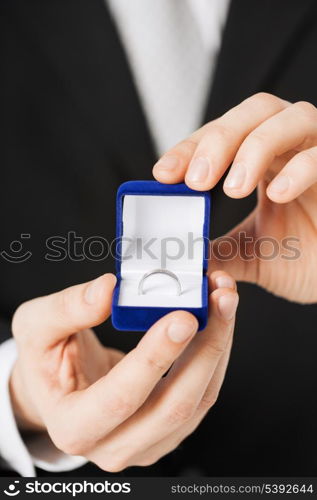 picture of man with gift box and wedding ring