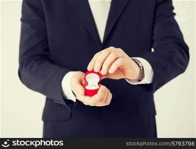 picture of man with gift box and wedding ring