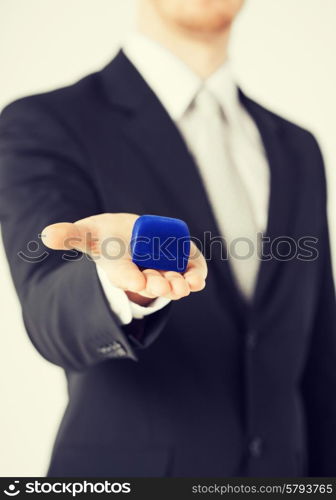 picture of man with gift box in suit