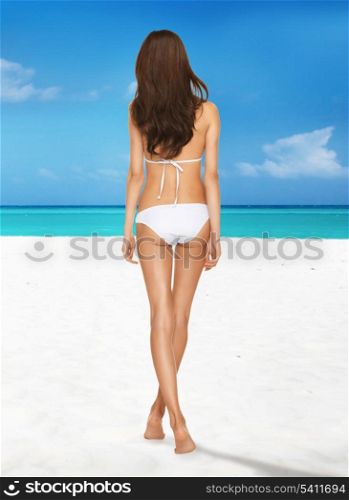 picture of model posing in white bikini on the beach