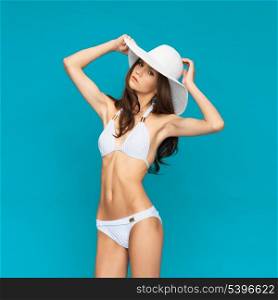 picture of model posing in white bikini with hat