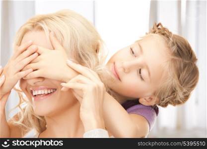 picture of mother and daughter making a joke or playing hide and seek