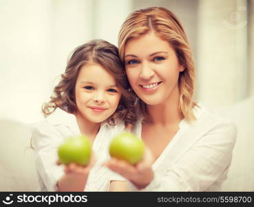 picture of mother and daughter with green apples