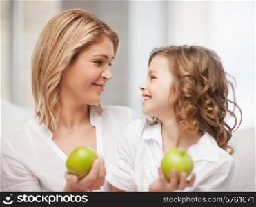 picture of mother and daughter with green apples