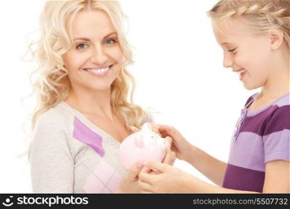 picture of mother and little girl with piggy bank (focus on woman)