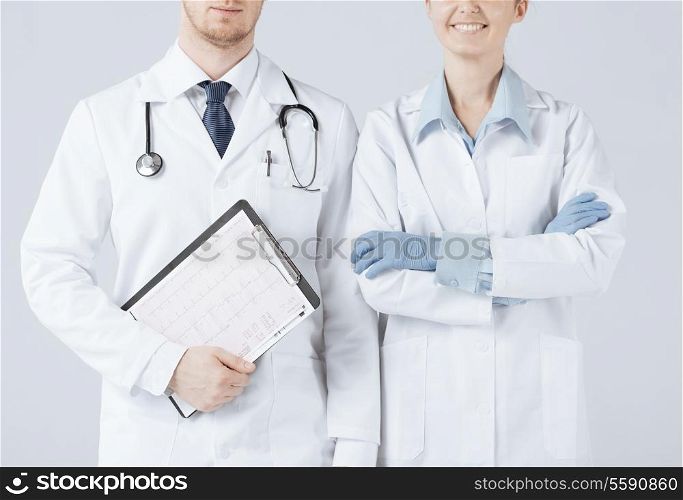 picture of nurse and male doctor holding cardiogram