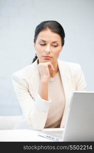 picture of pensive woman with laptop computer.