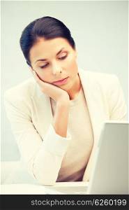 picture of pensive woman with laptop computer.. pensive woman with laptop computer