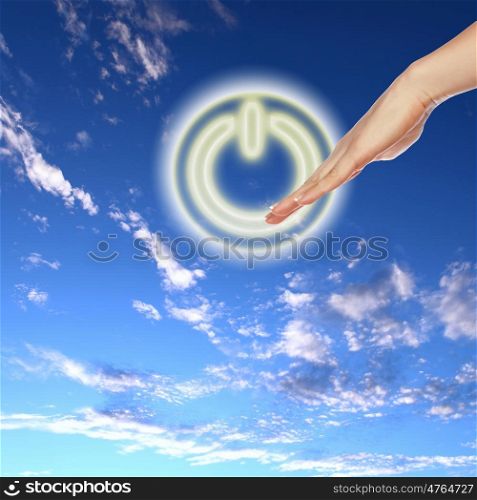 Picture of power button against blue sky background