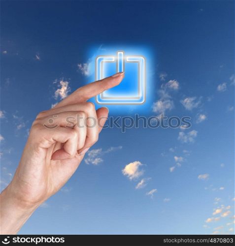 Picture of power button against blue sky background