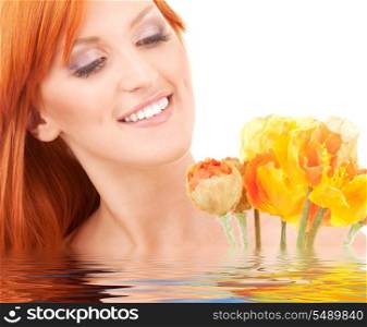 picture of redhead woman with flowers in water