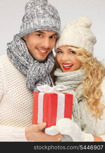 picture of romantic couple in a sweaters with gift box