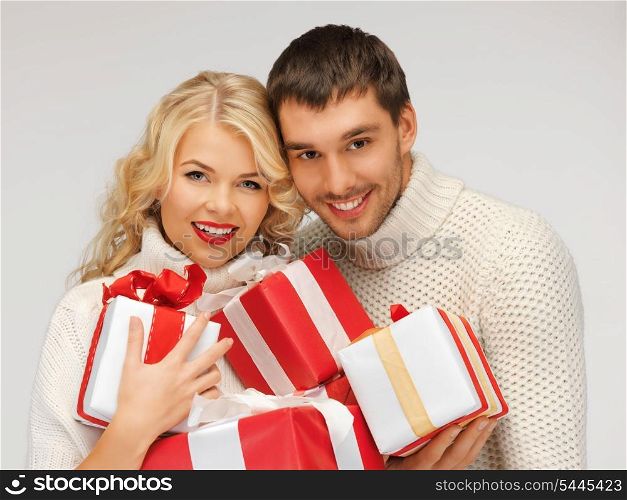 picture of romantic couple in a sweaters with gift boxes