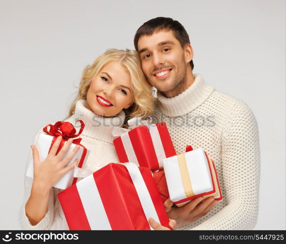 picture of romantic couple in a sweaters with gift boxes