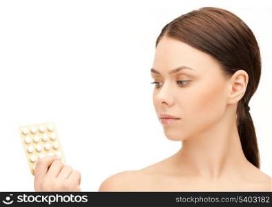 picture of sad young woman with pills