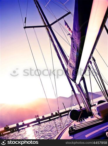 Picture of sailboat on purple sunset, luxury yacht in the sea, romantic vacation and travel, bright light in the sky, peaceful beach view, water sport, freedom and adventure concept